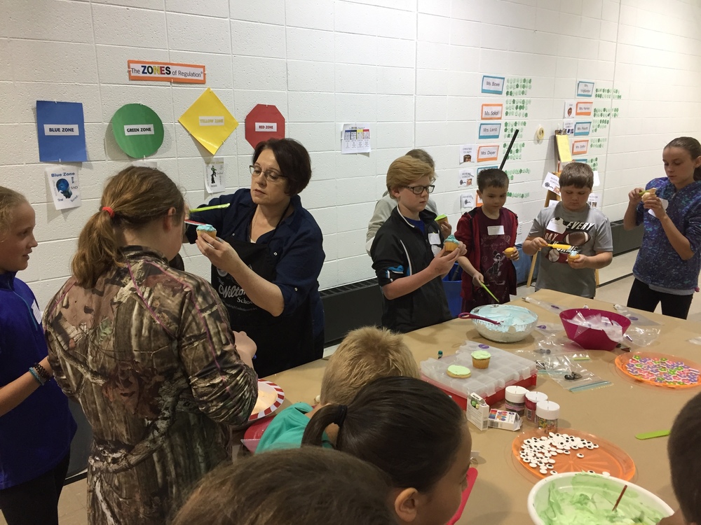 Students enjoying their session on cake/cooking decorating
